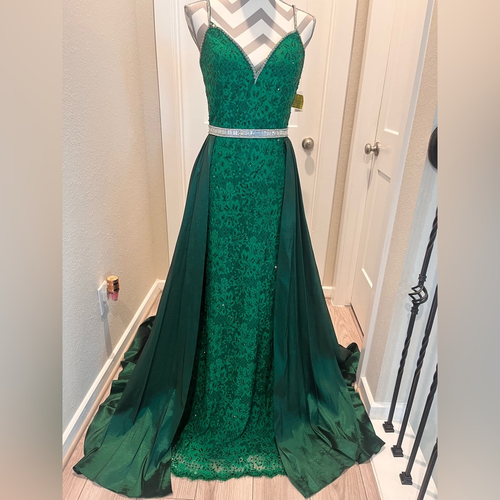 Johnathan Kayne Emerald. Green stretch gown with an overlay skirt, studded belt.